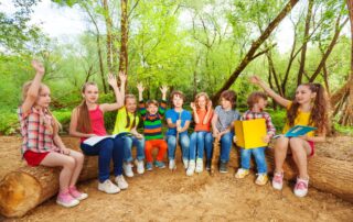 Kids at camp on a log