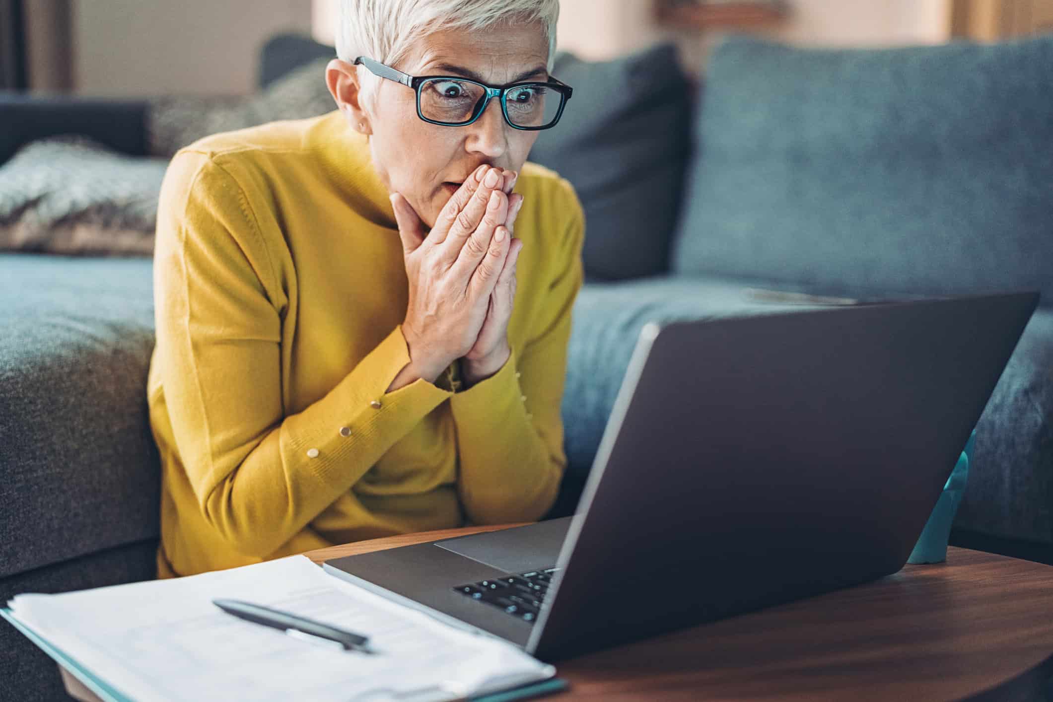 Concerned woman reviewing information on laptop
